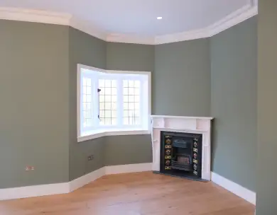 Luxury living room refurbishment with feature fireplace and bay window in Loughton Essex