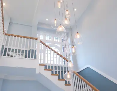 Luxury feature staircase with vaulted ceiling and pendant lighting in Loughton Essex home