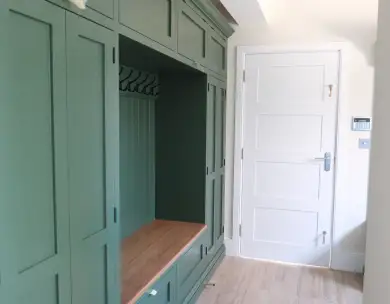 Bespoke fitted hallway storage and seating area in luxury Loughton home