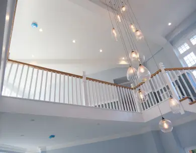 Luxury mezzanine interior with bespoke staircase and pendant lighting in Loughton Essex