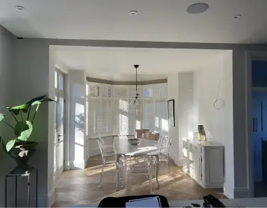 Luxury open plan dining area with bay window and plantation shutters in Loughton Essex