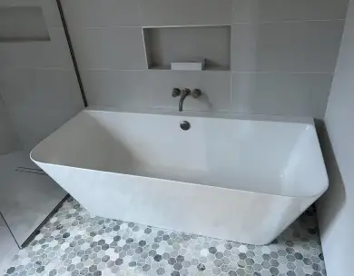 Luxury modern bathroom with freestanding bath and contemporary tiling in Loughton Essex