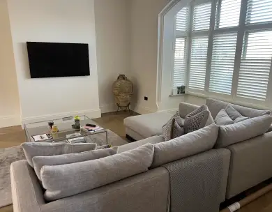 Luxury modern living room with bespoke seating and plantation shutters in Loughton Essex