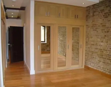 Luxury bespoke wardrobe installation with exposed brickwork in Loughton Essex