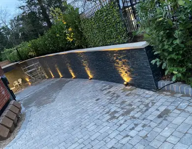 Luxury driveway landscaping with illuminated retaining wall in Chigwell Essex