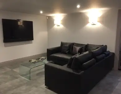 Modern basement cinema room with lounge area in Ongar Essex
