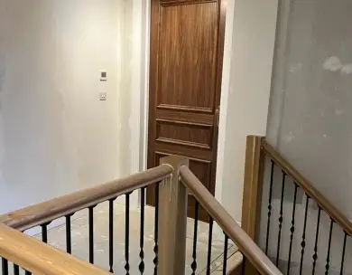 Luxury staircase landing with oak handrails and bespoke interior finishes in Epping Essex