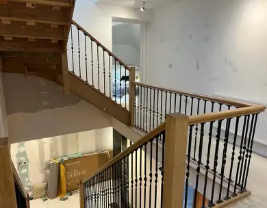 Luxury oak staircase landing with bespoke balustrades in Epping Essex