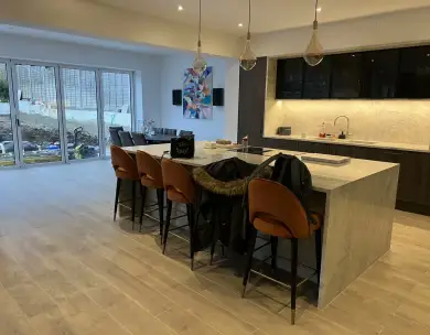 Modern open plan kitchen extension with central island and sliding doors in Loughton Essex