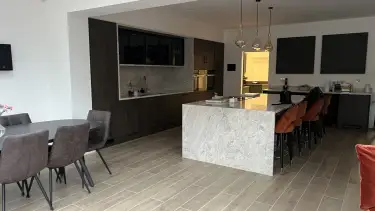 Modern open plan kitchen with large marble island and dining area in Loughton Essex