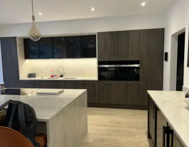 Modern bespoke kitchen renovation with central island and integrated appliances in Loughton Essex