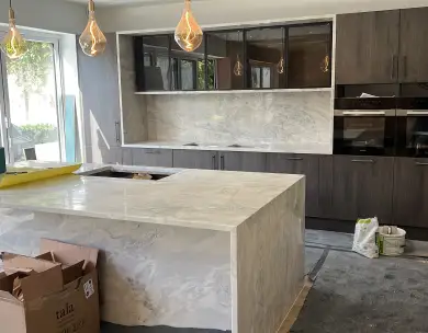 Modern bespoke kitchen installation with central island and integrated appliances in Loughton Essex