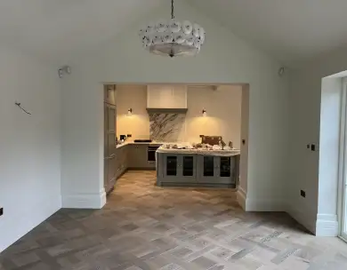 Luxury open plan kitchen view with bespoke island and herringbone flooring in Loughton Essex