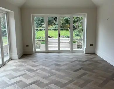 Luxury open plan living extension with herringbone flooring and garden doors in Loughton Essex
