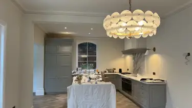 Luxury grey kitchen interior with bespoke cabinetry and designer lighting in Loughton Essex