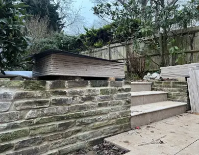 Landscaped garden with stone retaining wall and steps in Loughton Essex
